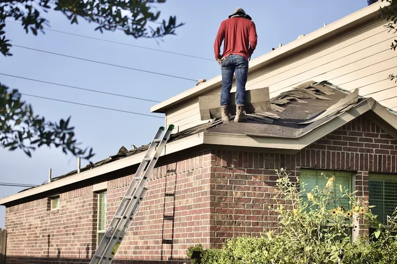 Professional roofer working on a residential roof in New Munich